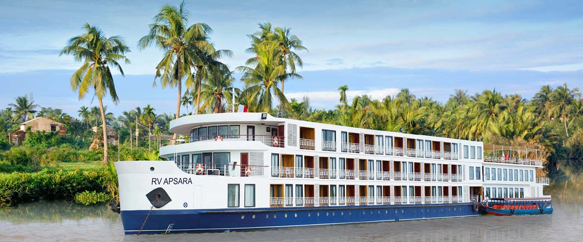 View of RV Apsara with palm trees behind on Mekong River
