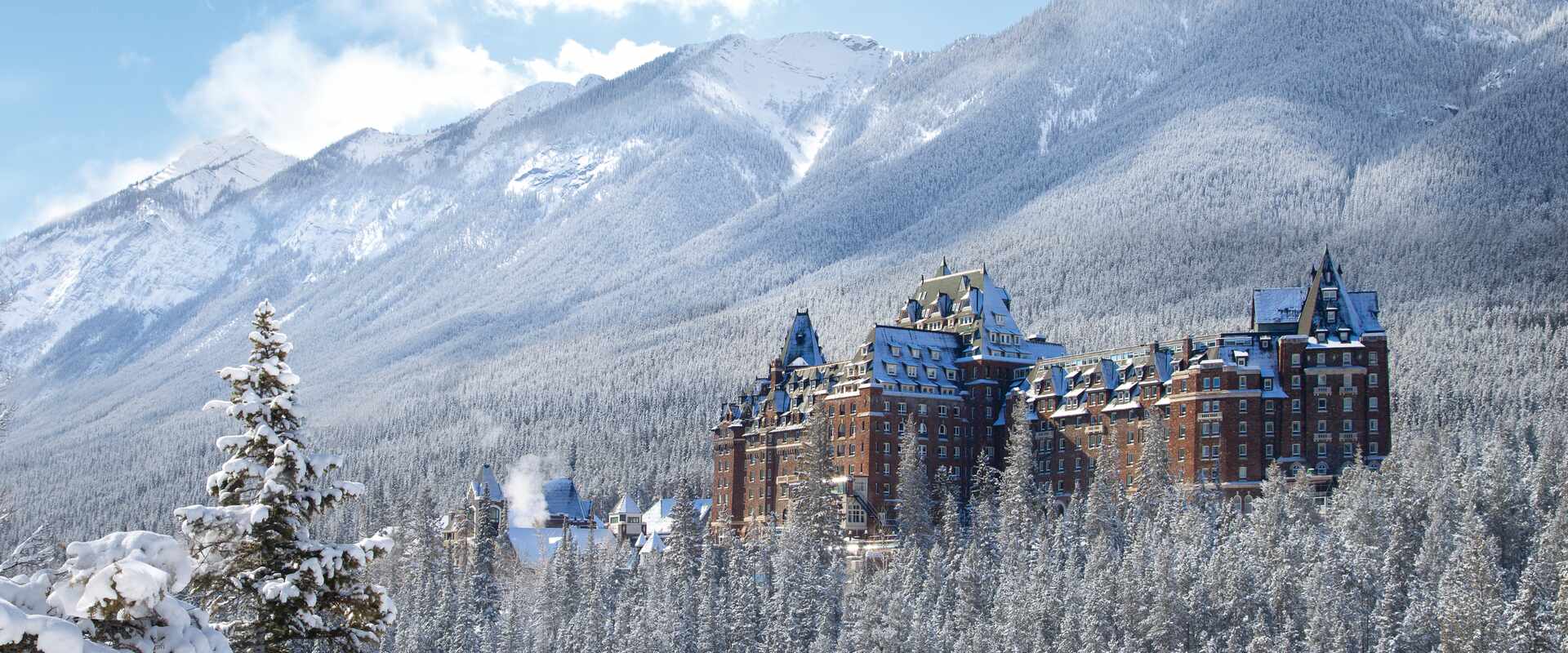 View of hotel in wither over snow covered tree tops, Canada