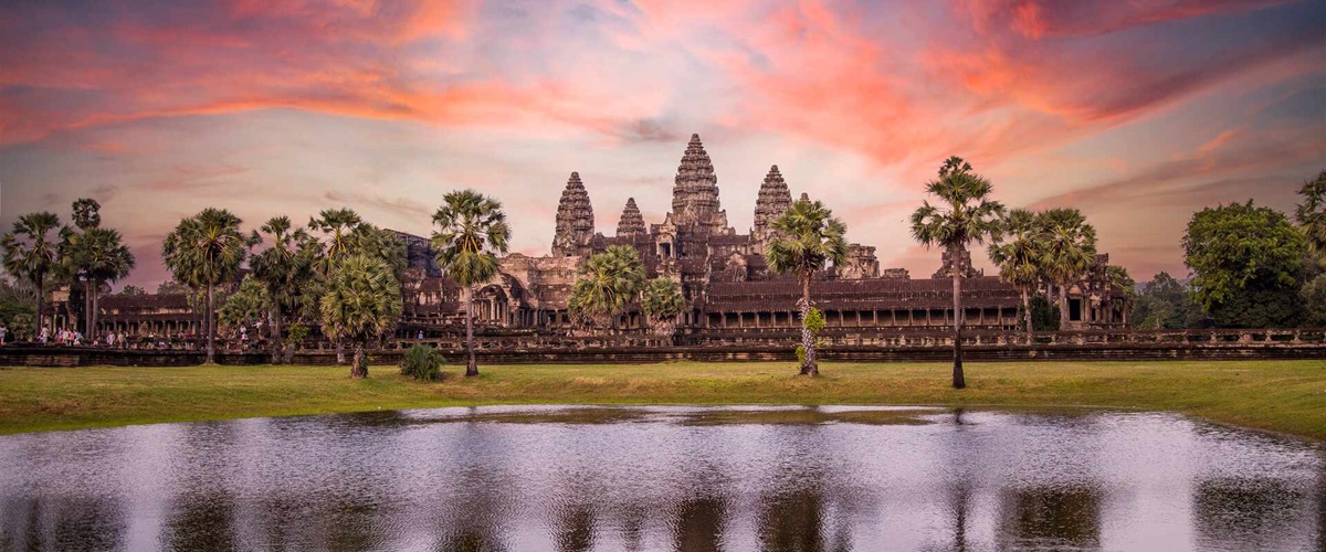 Angkor Wat main temple reflected in the water in a beautiful summer sunrise in Cambodia