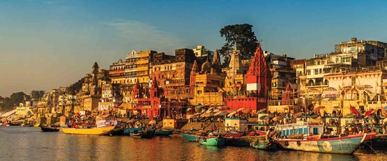 View of colourful coastal village at sunset, India