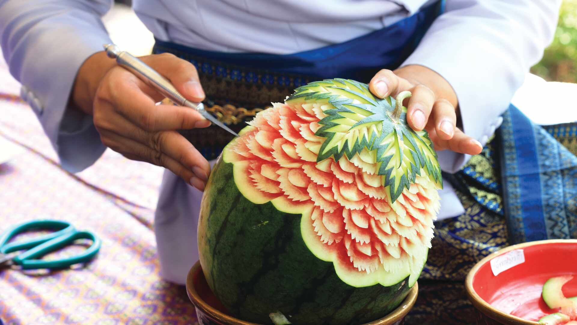 Person carving watermelon, Vietnam