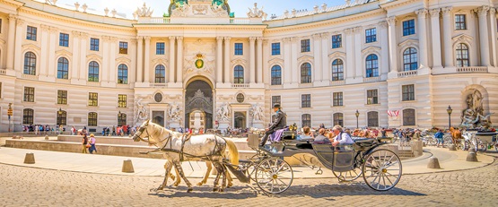 Tourists sightseeing in Alte Hofburg, Vienna, Austria