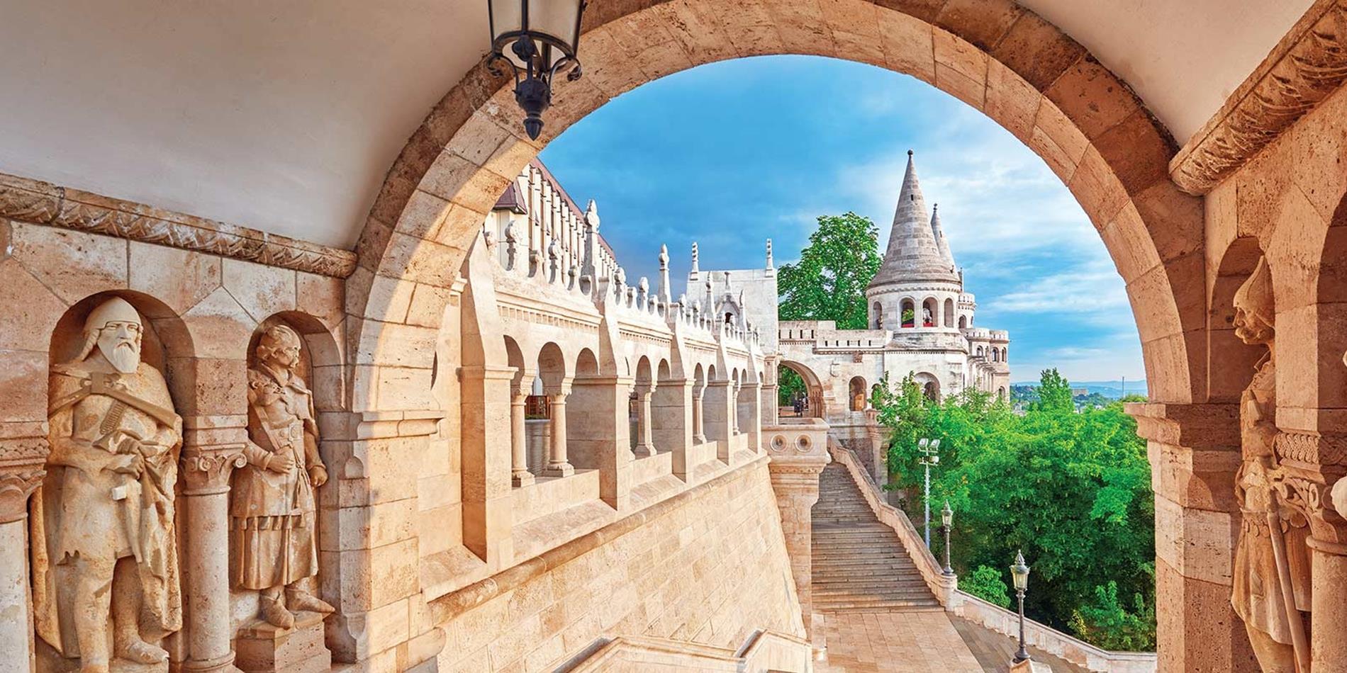View of fisherman's bastion through archway with blue sky
