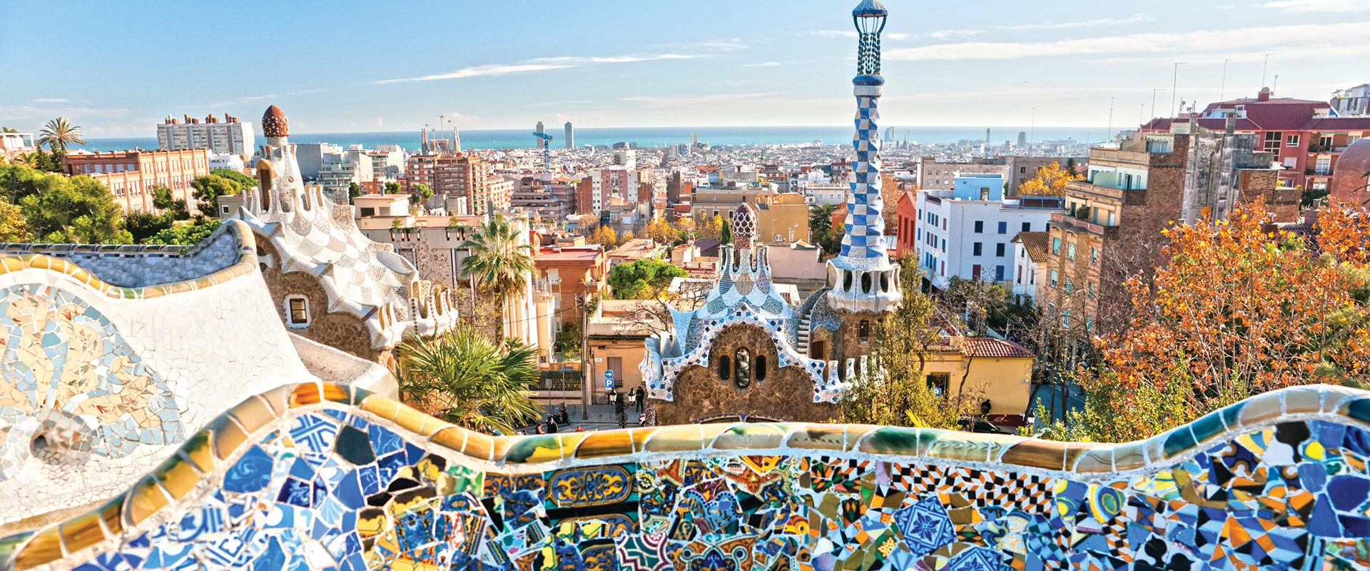 View of colourful tiled wall and vibrant buildings in Park Guell, Barcelona