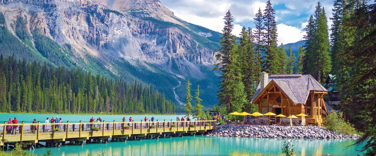 Emerald Lake Lodge surrounded by towering peaks, pines and blue waters.