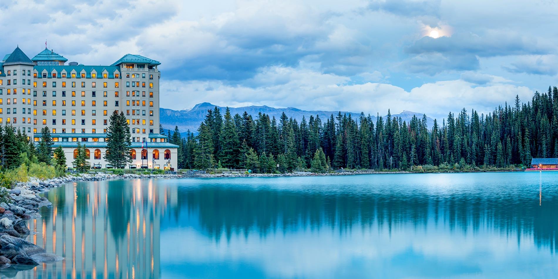 Fairmont Lake Louise hotel with reflection in lake at dusk