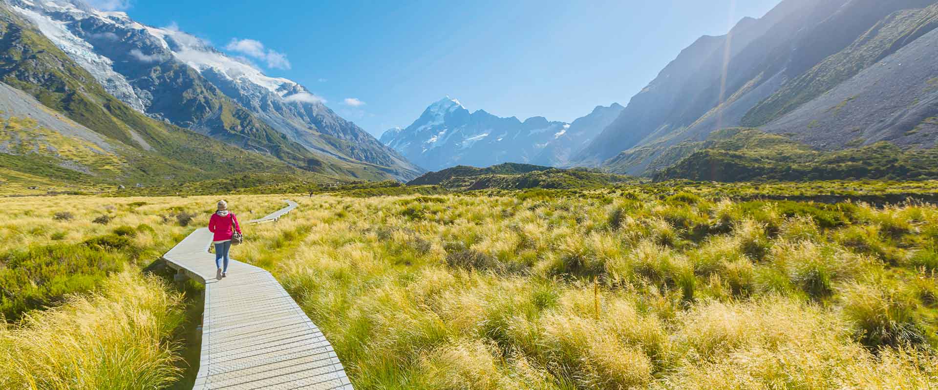 Woman walking along Mount Cook national park boardwalk, South Island New Zealand