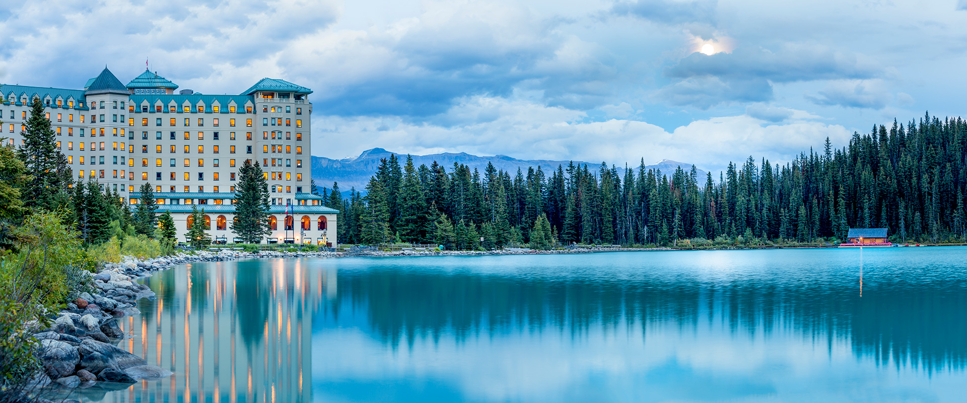 Fairmont Lake Louise hotel with reflection in lake at dusk