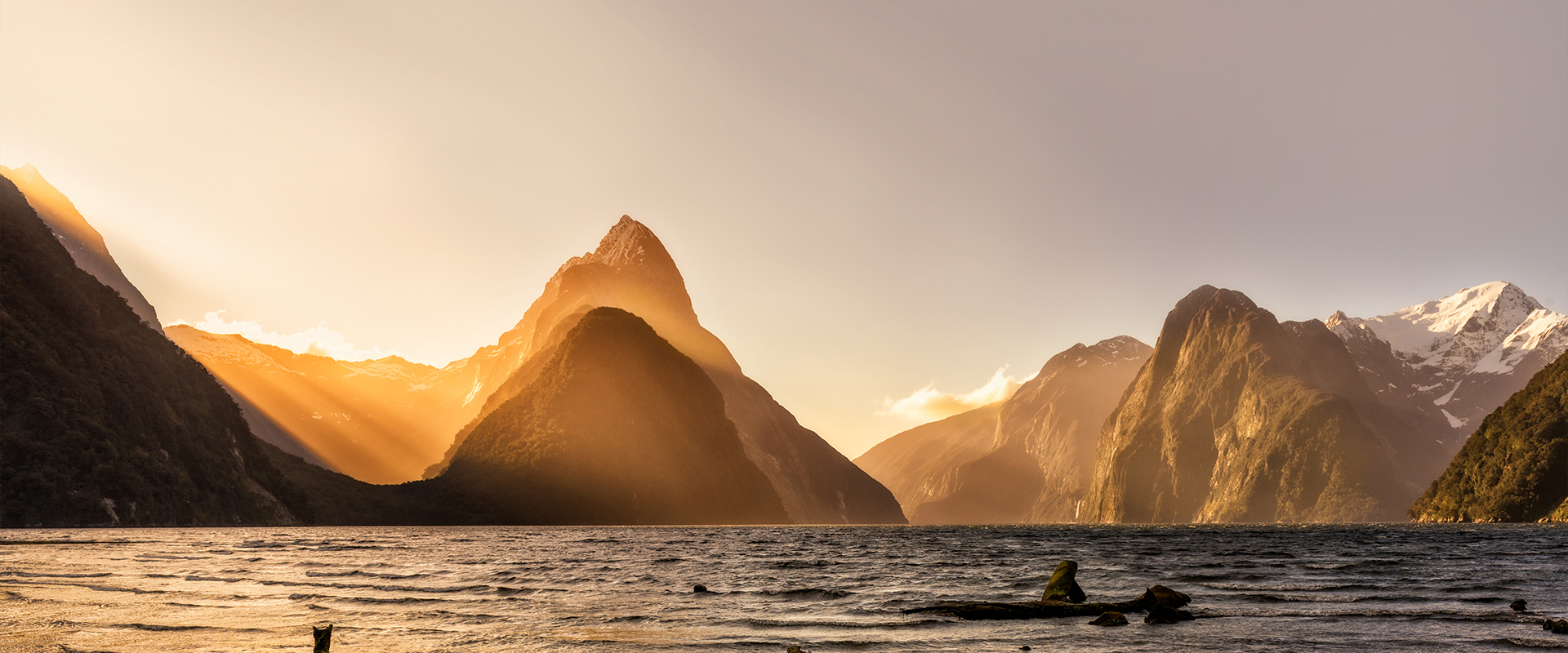 View across the water towards the mountains surrounding Milford Sound, New Zealand