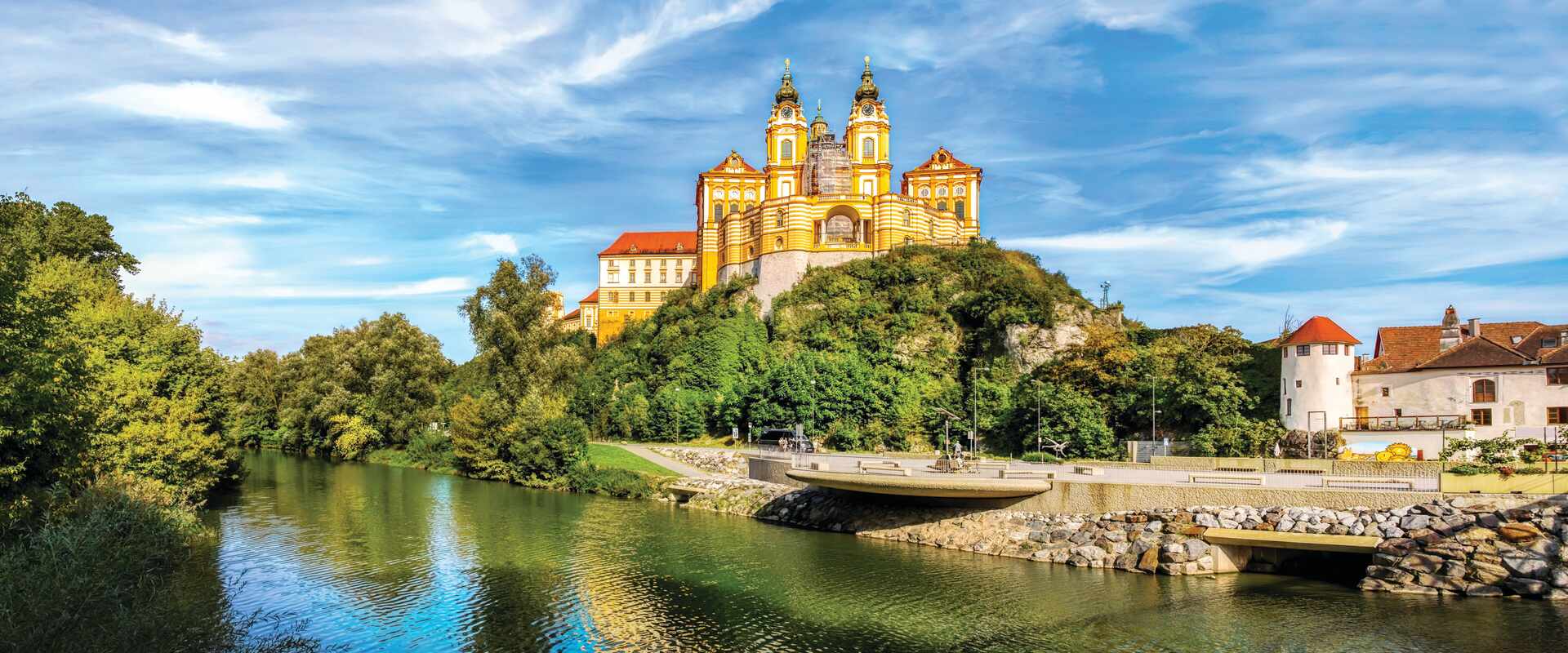 View of Melk abbey on hill infront of river, Austria